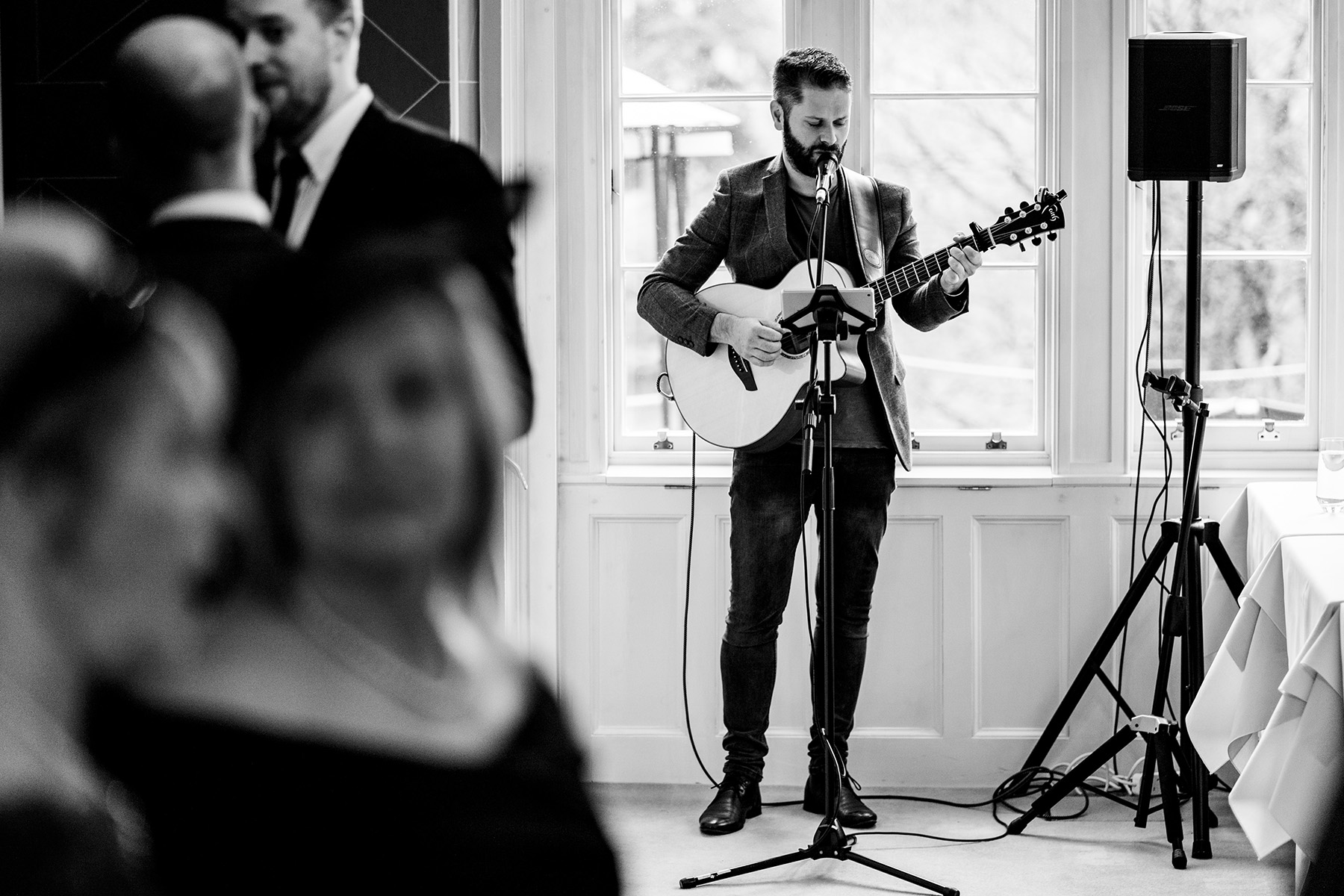 The Devon Wedding Singer performing an acoustic guitar set at an indoor wedding reception – professional musician Ollie Stephens